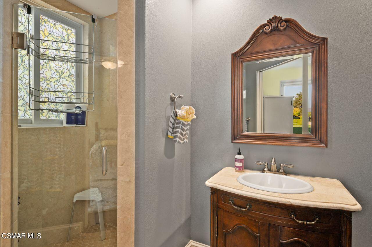 12490 MacDonald Drive Ojai, CA 93023 - Photo 32 of 87 a bathroom with a sink a mirror and a window