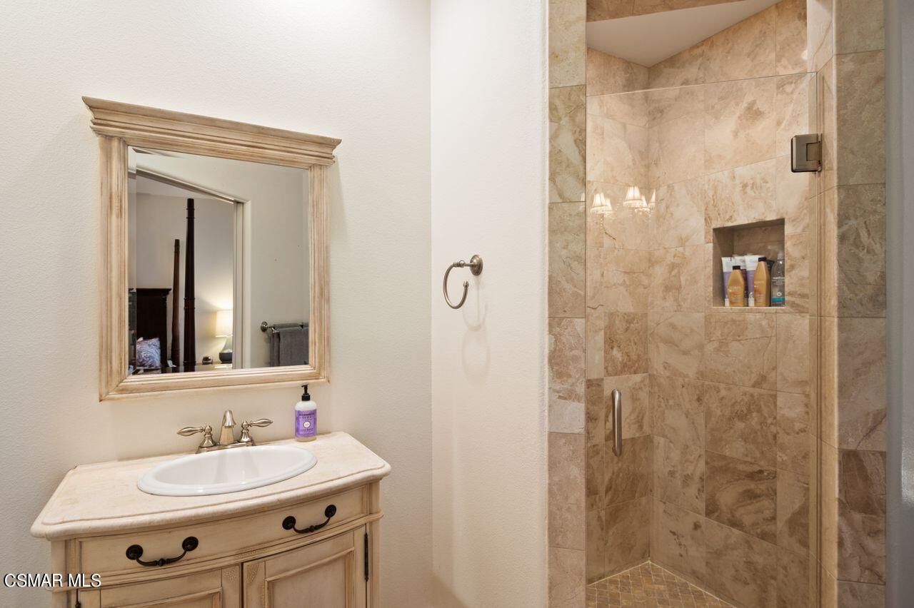 12490 MacDonald Drive Ojai, CA 93023 - Photo 34 of 87 a bathroom with a sink a mirror and shower