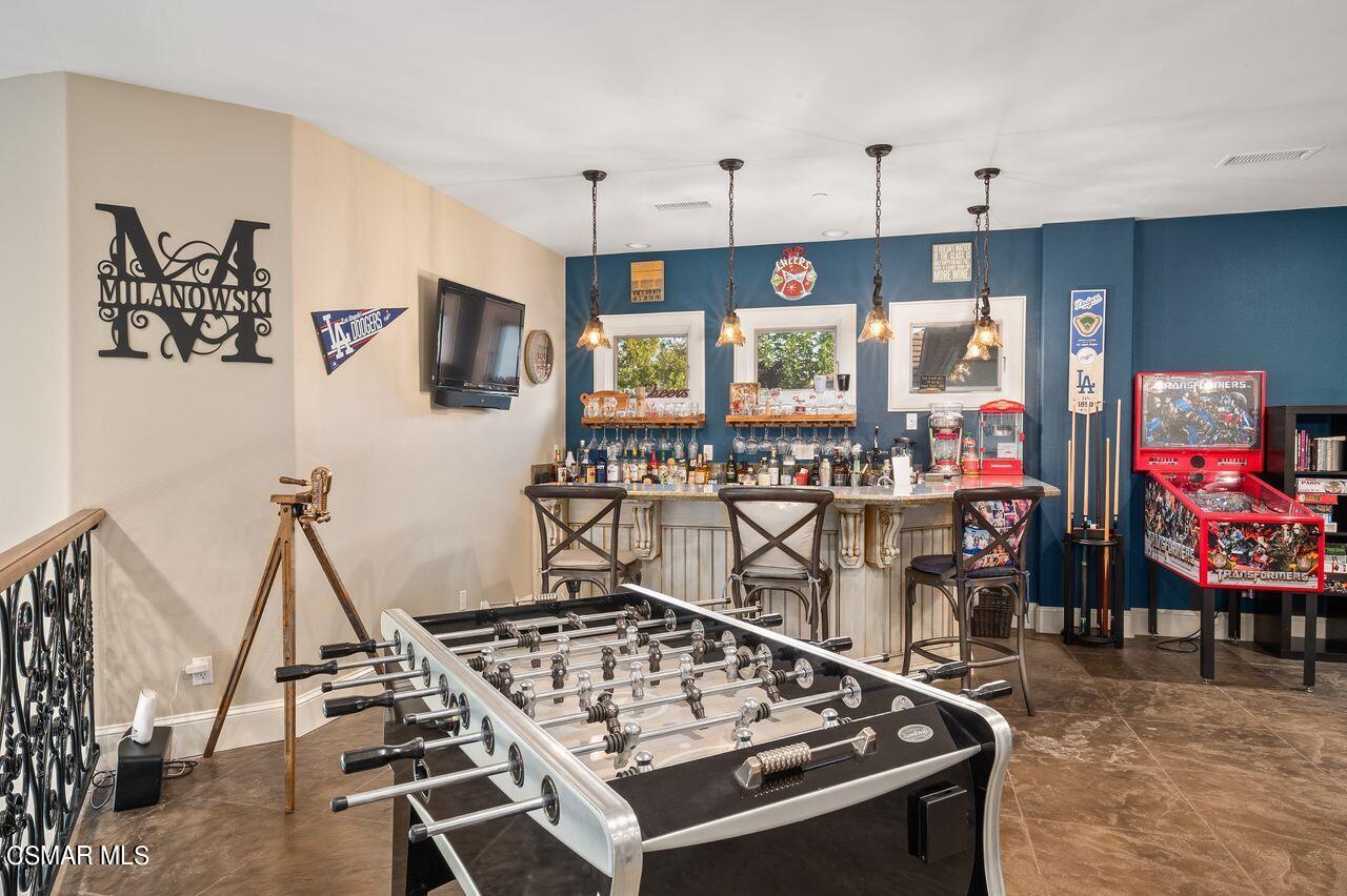 12490 MacDonald Drive Ojai, CA 93023 - Photo 38 of 87 a kitchen with a stove a refrigerator and a dining table
