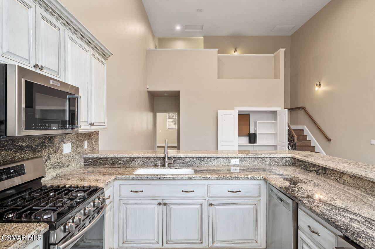 12490 MacDonald Drive Ojai, CA 93023 - Photo 54 of 87 a kitchen with granite countertop a sink stove and cabinets