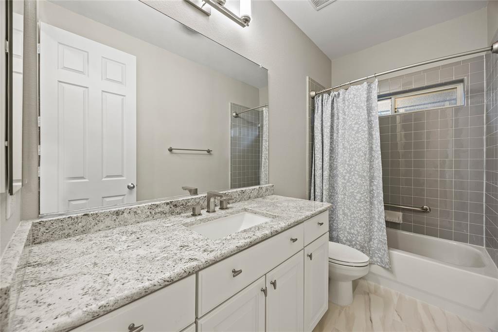 10409 Countryside Drive Denton, TX 76207 - Photo 30 of 38 Second Full bath with vanity with granite countertops and shower / bath combination with curtain