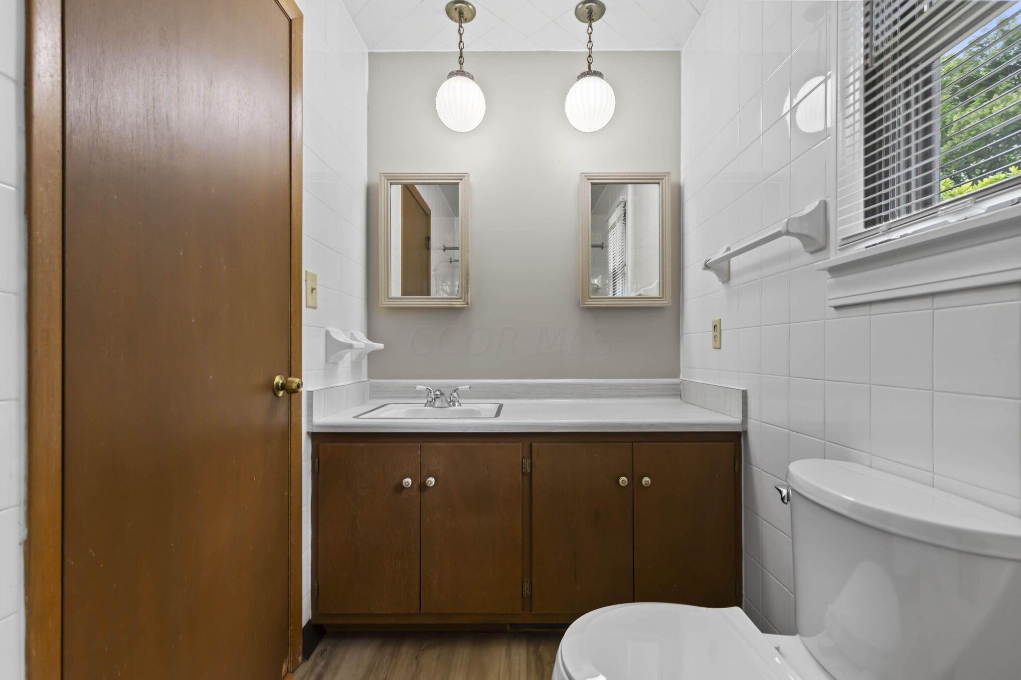 999 Birchmont Road Columbus, OH 43220 - Photo 25 of 53 Large vanity in the full bath with dual mirrors and storage.