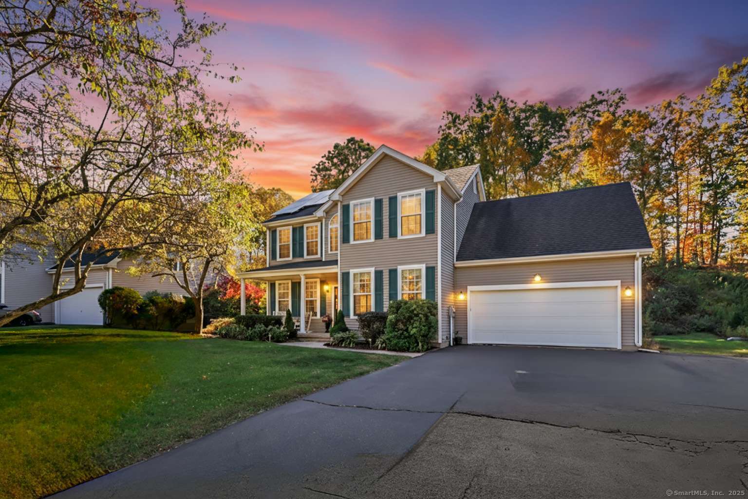 a front view of a house with a garden and yard
