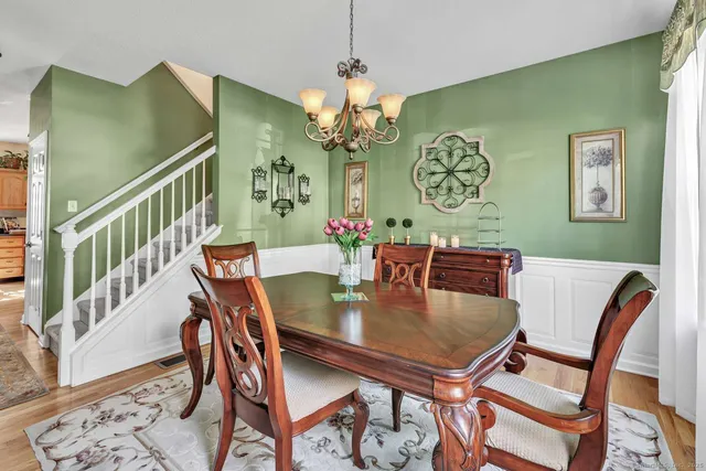 a view of a dining room with furniture and a chandelier