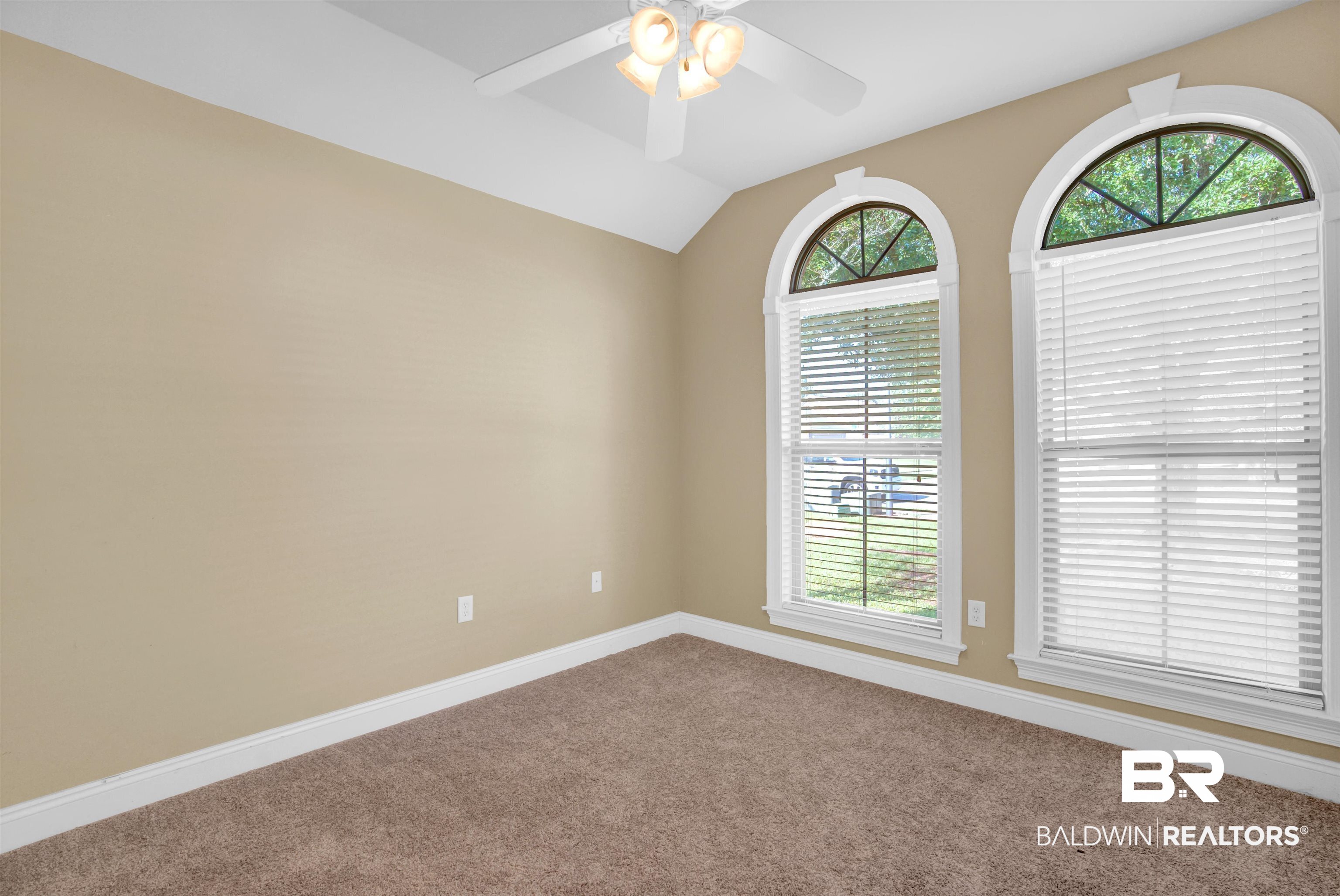 9532 Collier Loop Daphne, AL 36526 - Photo 11 of 45 Carpeted spare room with a healthy amount of sunlight, vaulted ceiling, and ceiling fan