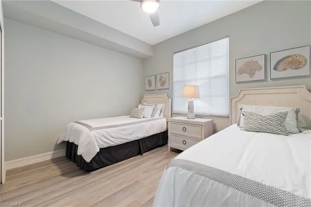 a bedroom with two beds and a chandelier