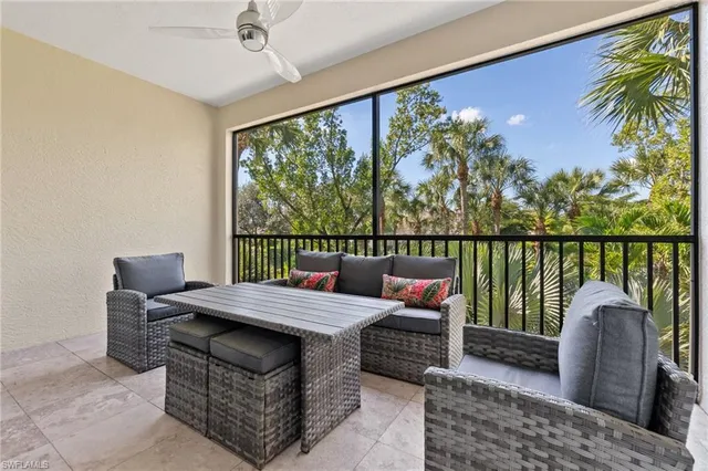 a living room with furniture a lamp and a potted plant