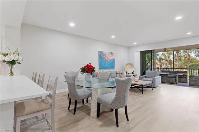 a dining room with furniture and a potted plant