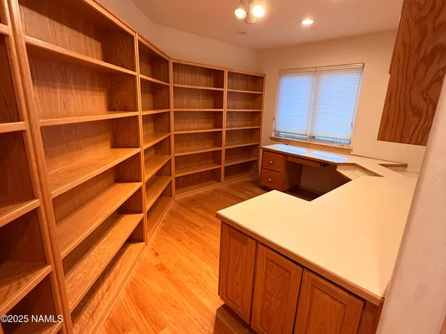 a view of walk in closet with empty racks