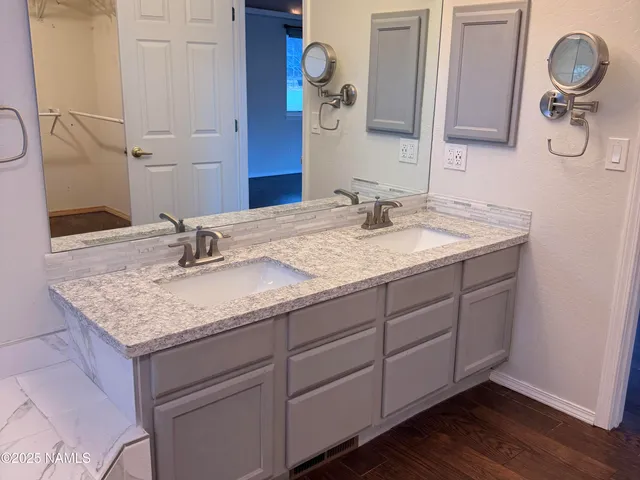 a bathroom with a granite countertop sink and a mirror