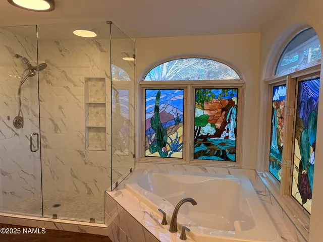 a bathroom with a tub and a shower