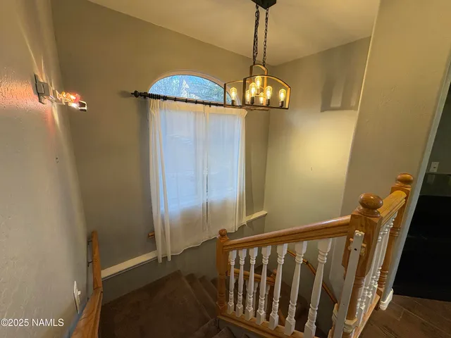 a view of a hallway with a chandelier