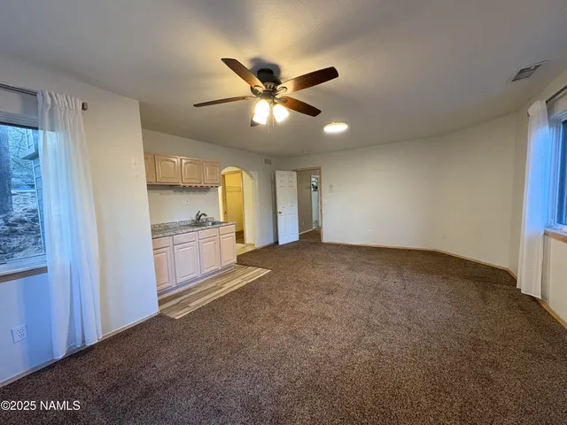 a view of a kitchen with a sink and a refrigerator