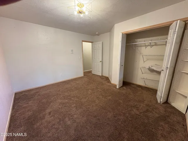 an empty room with closet area