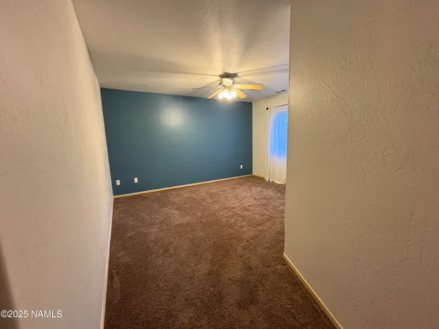 an empty room with fan and fan