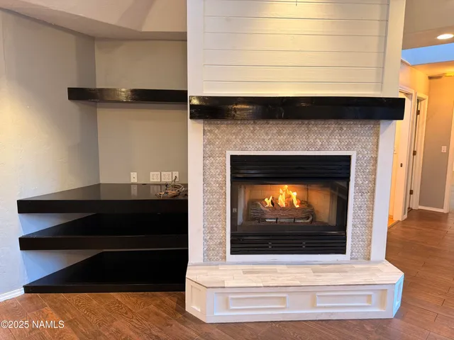 a living room with a fireplace and a wooden floor
