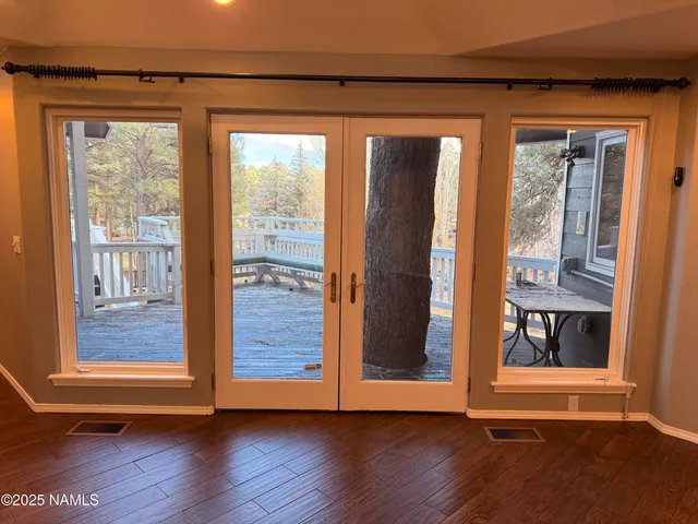 a view of an entryway with wooden floor and door