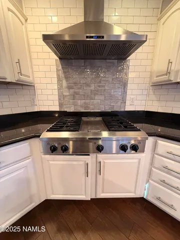 a close view of a stove a microwave and cabinets
