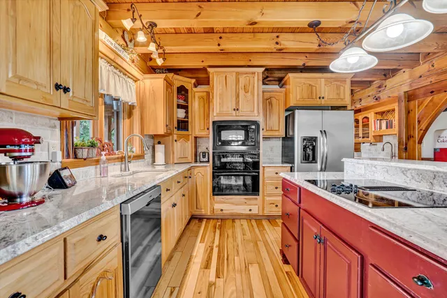 a living room with furniture floor to ceiling window and wooden floor