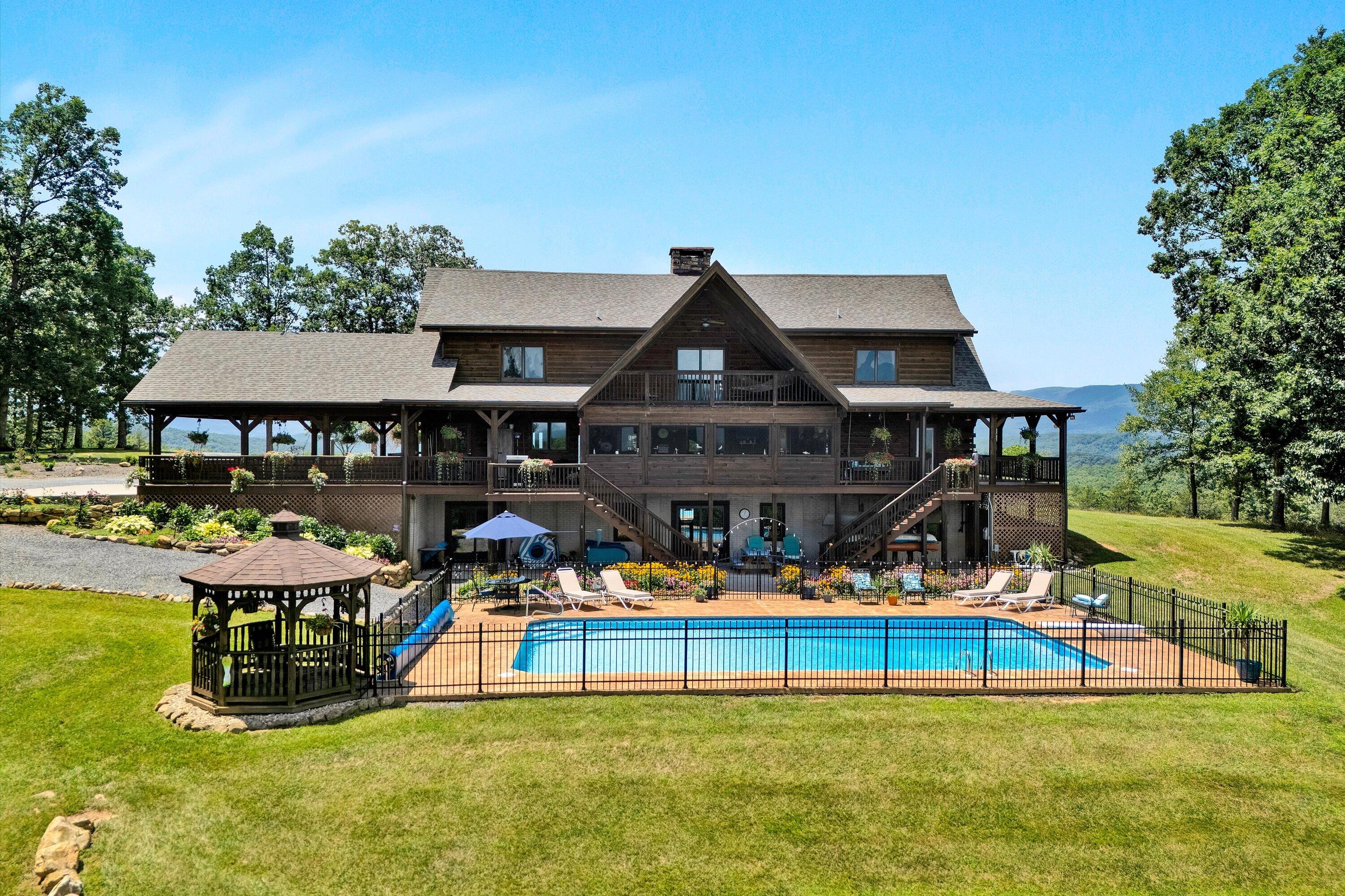 500 Jacksons Flat Covington, VA 24426 - Photo 94 of 102 a view of a swimming pool with lawn chairs under an umbrella