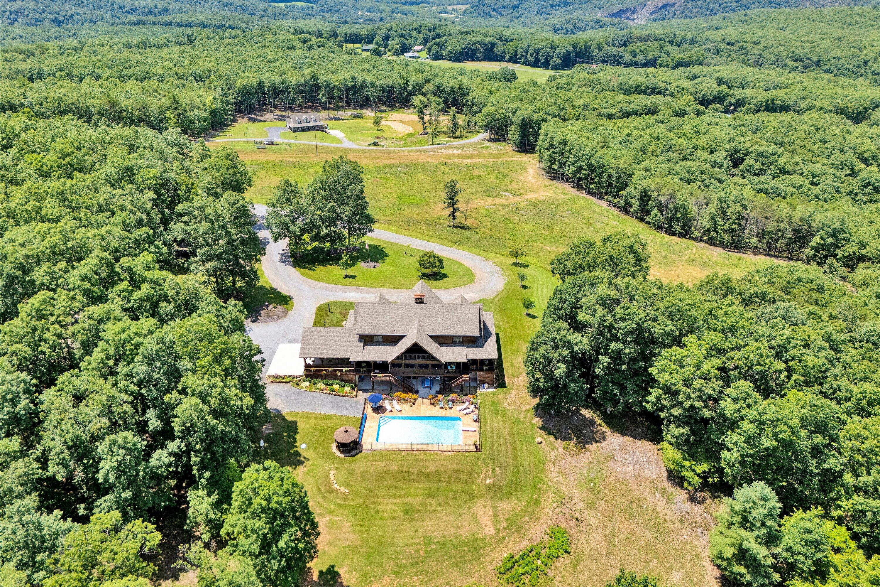 500 Jacksons Flat Covington, VA 24426 - Photo 97 of 102 a view of a swimming pool with lawn chairs and large trees