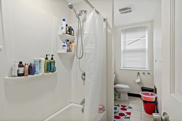 a bathroom with a shower toilet and a sink
