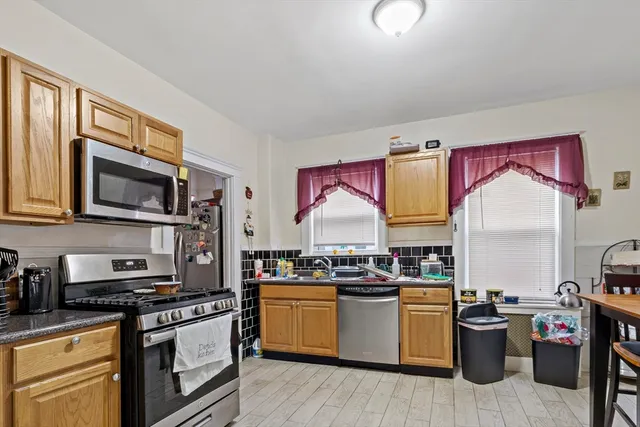 a kitchen with stainless steel appliances granite countertop a stove and a sink