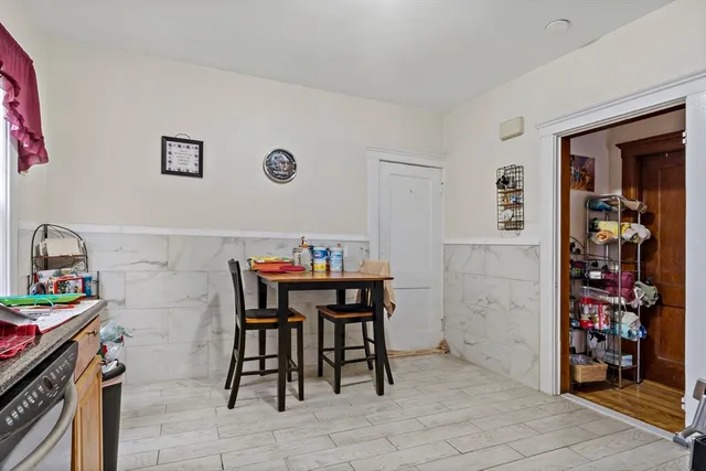 a view of a dining room with workspace and a window