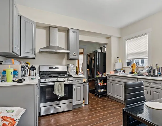 a kitchen with a stove a sink and a refrigerator