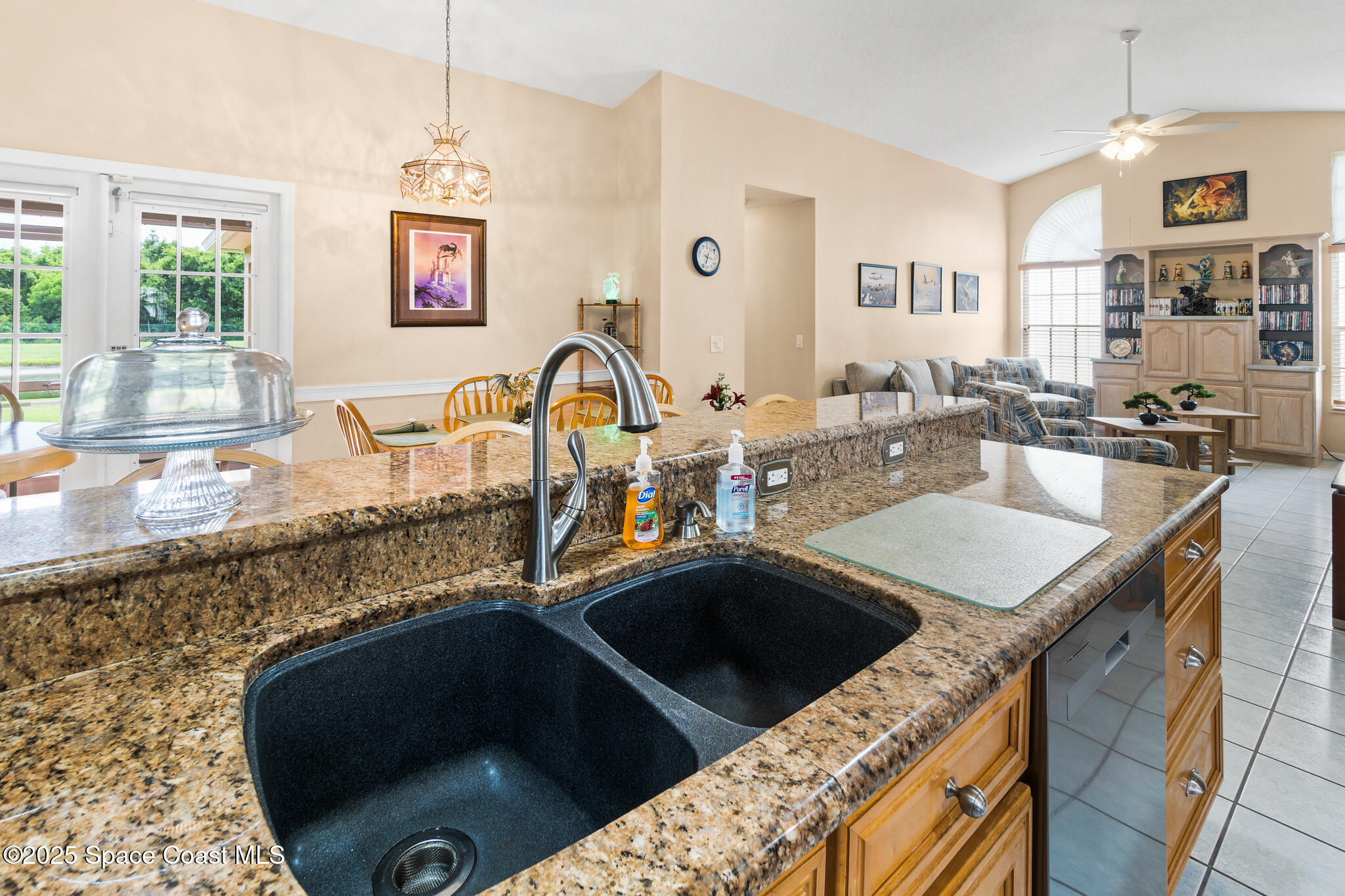 4808 Springwater Circle Melbourne, FL 32940 - Photo 12 of 38 a kitchen with stainless steel appliances granite countertop a sink stove and cabinets
