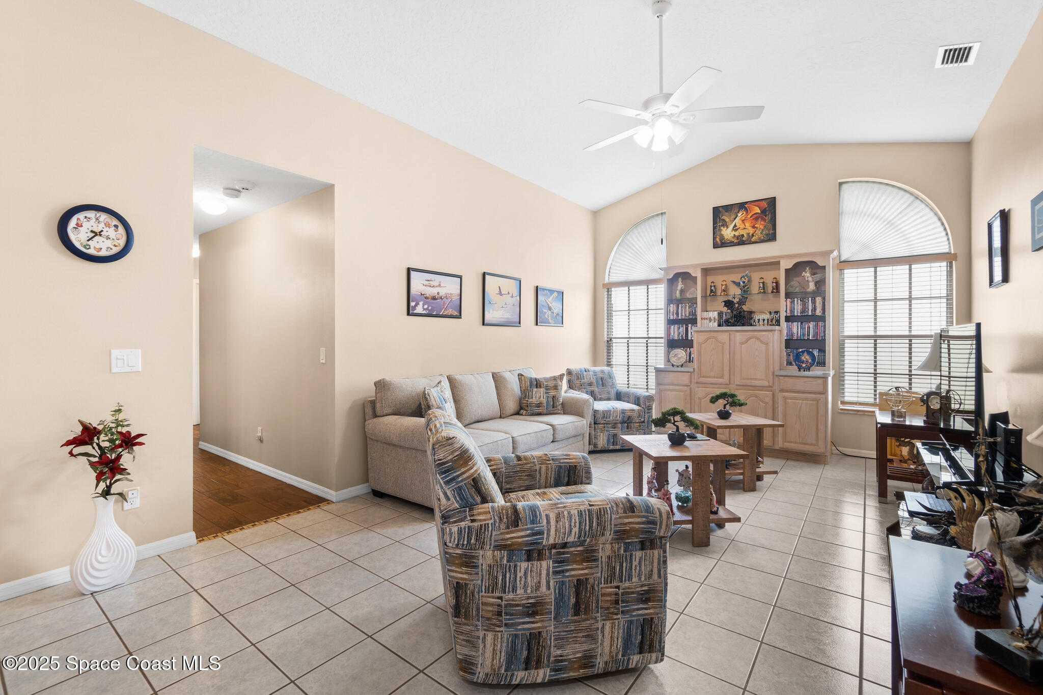4808 Springwater Circle Melbourne, FL 32940 - Photo 14 of 38 a living room with furniture chandelier and a window