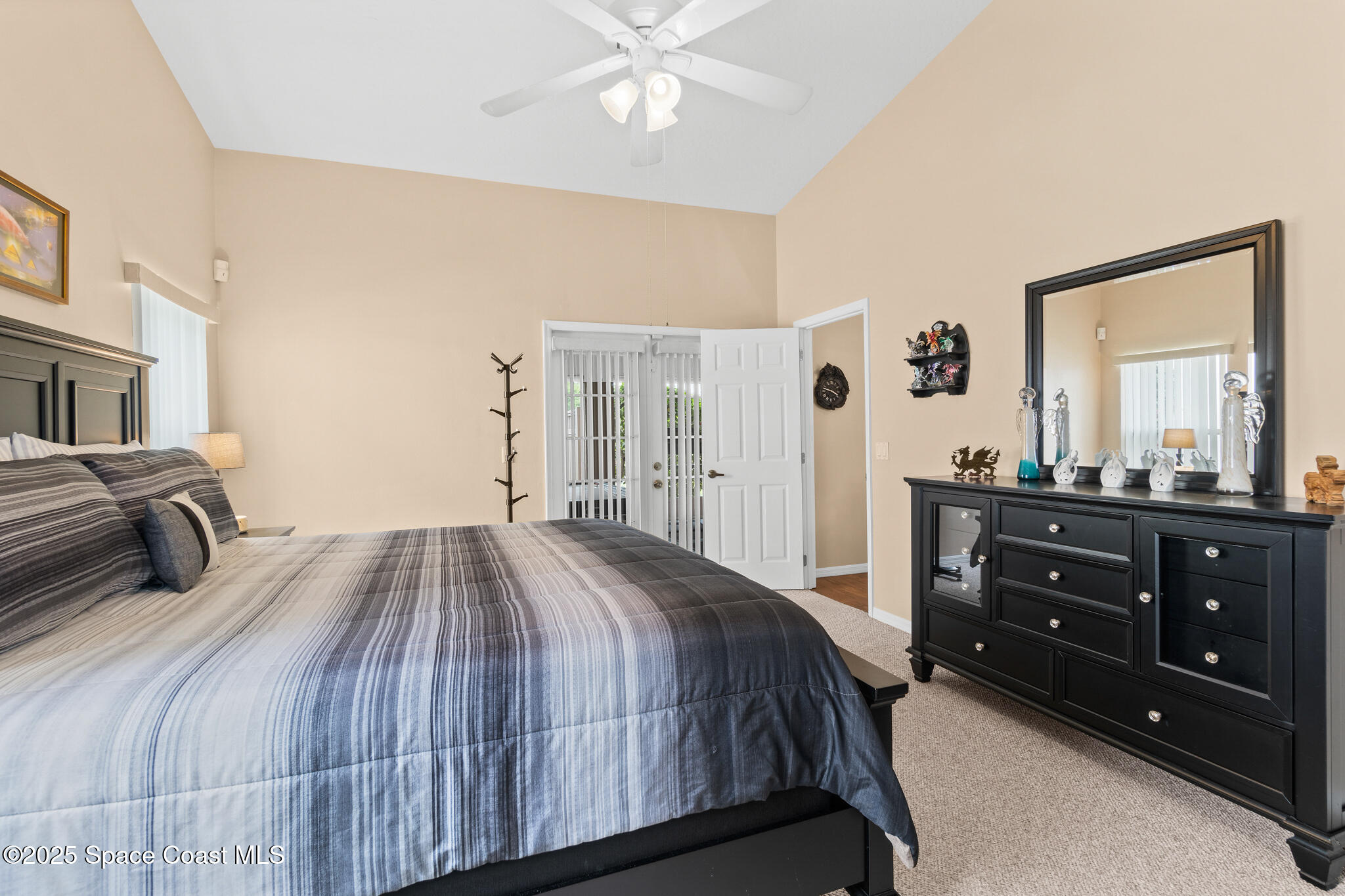 4808 Springwater Circle Melbourne, FL 32940 - Photo 15 of 38 a bedroom with a bed and a dresser