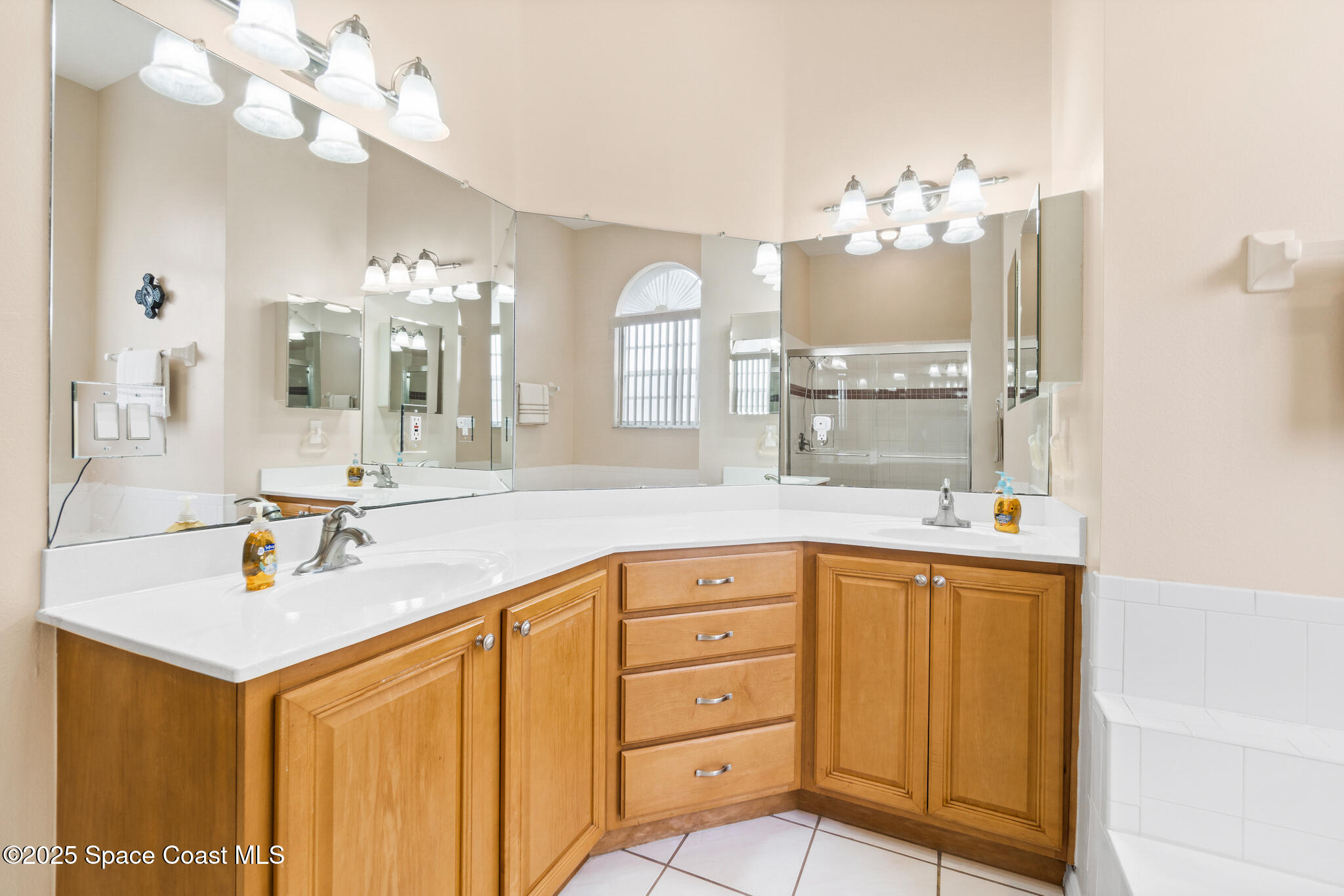 4808 Springwater Circle Melbourne, FL 32940 - Photo 16 of 38 a bathroom with a sink vanity and mirror
