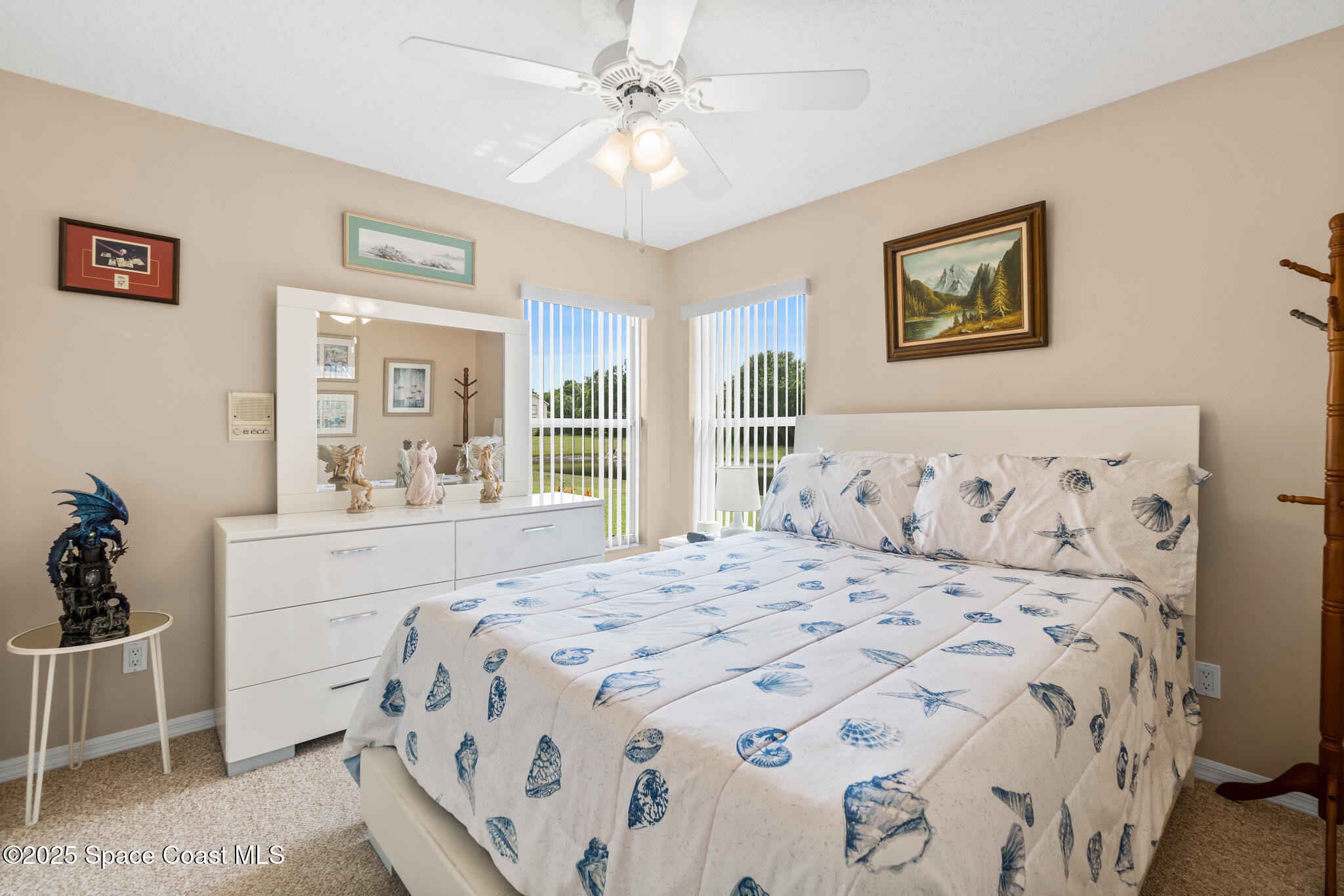4808 Springwater Circle Melbourne, FL 32940 - Photo 19 of 38 a bedroom with a large bed and a chandelier