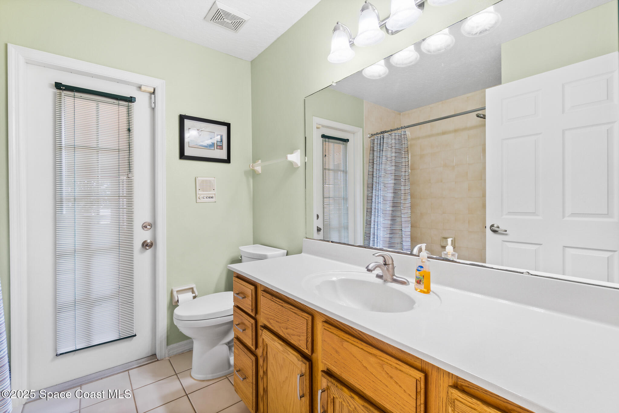 4808 Springwater Circle Melbourne, FL 32940 - Photo 23 of 38 a bathroom with a granite countertop sink a toilet and shower