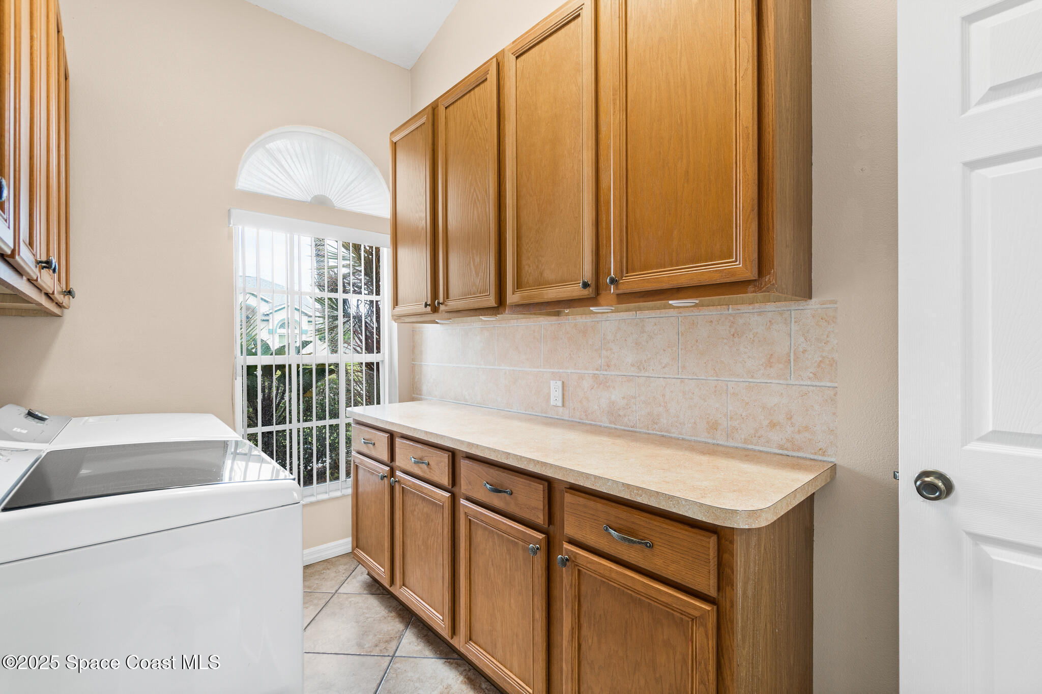4808 Springwater Circle Melbourne, FL 32940 - Photo 25 of 38 a utility room with dryer and washer
