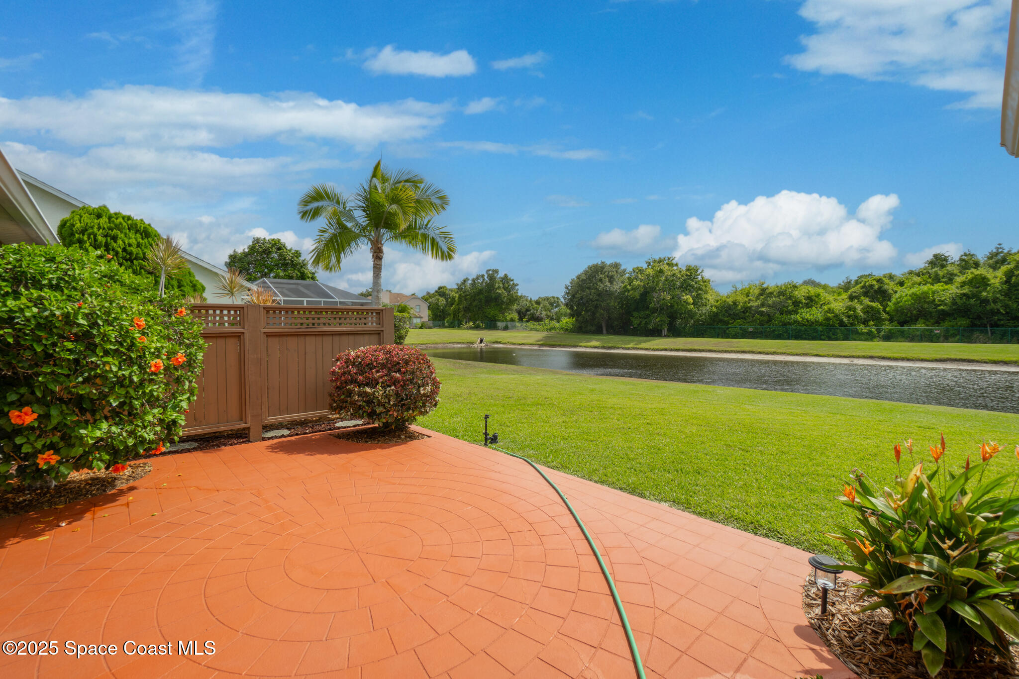 4808 Springwater Circle Melbourne, FL 32940 - Photo 33 of 38 a view of a swimming pool and trees in the background