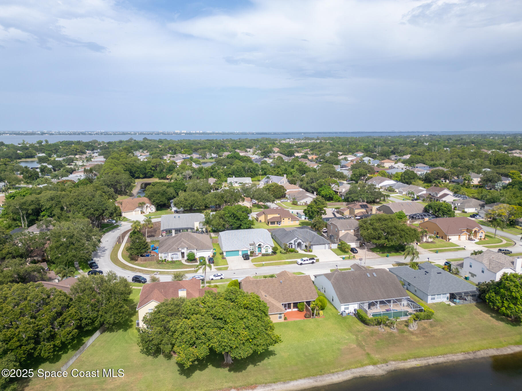 4808 Springwater Circle Melbourne, FL 32940 - Photo 36 of 38 an aerial view of residential houses with outdoor space and trees