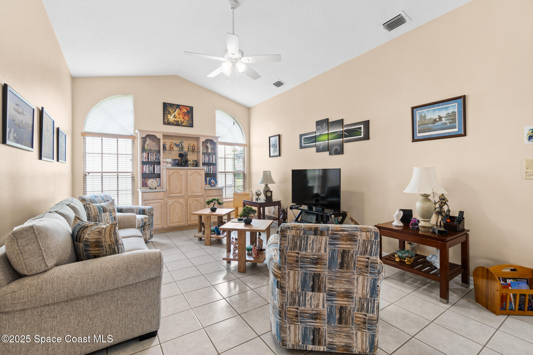 4808 Springwater Circle Melbourne, FL 32940 - Photo 4 of 38 a living room with furniture a flat screen tv and a window