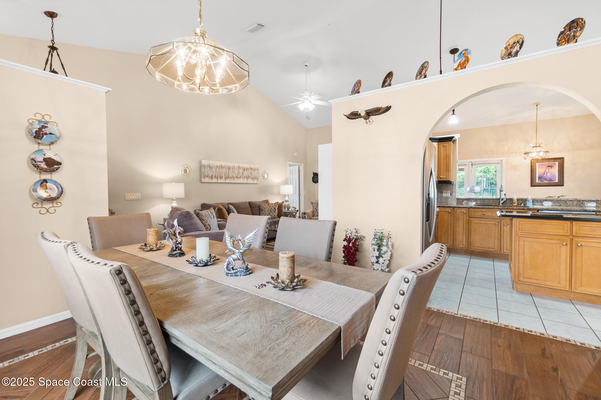 4808 Springwater Circle Melbourne, FL 32940 - Photo 5 of 38 a view of a dining room with furniture a chandelier and wooden floor