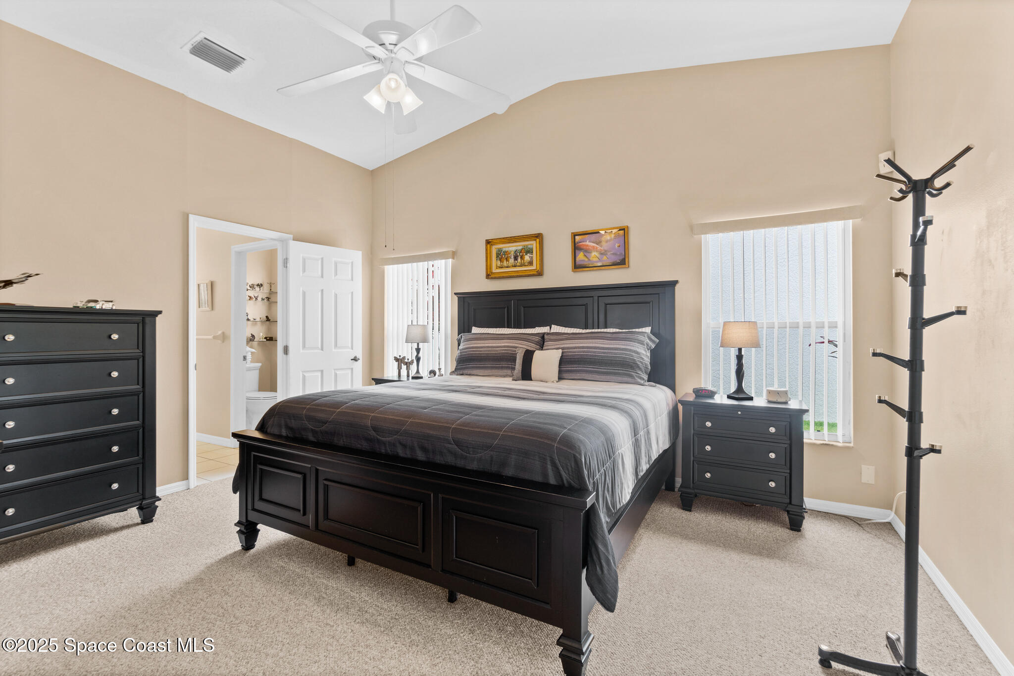 4808 Springwater Circle Melbourne, FL 32940 - Photo 6 of 38 a bedroom with a bed and a chandelier