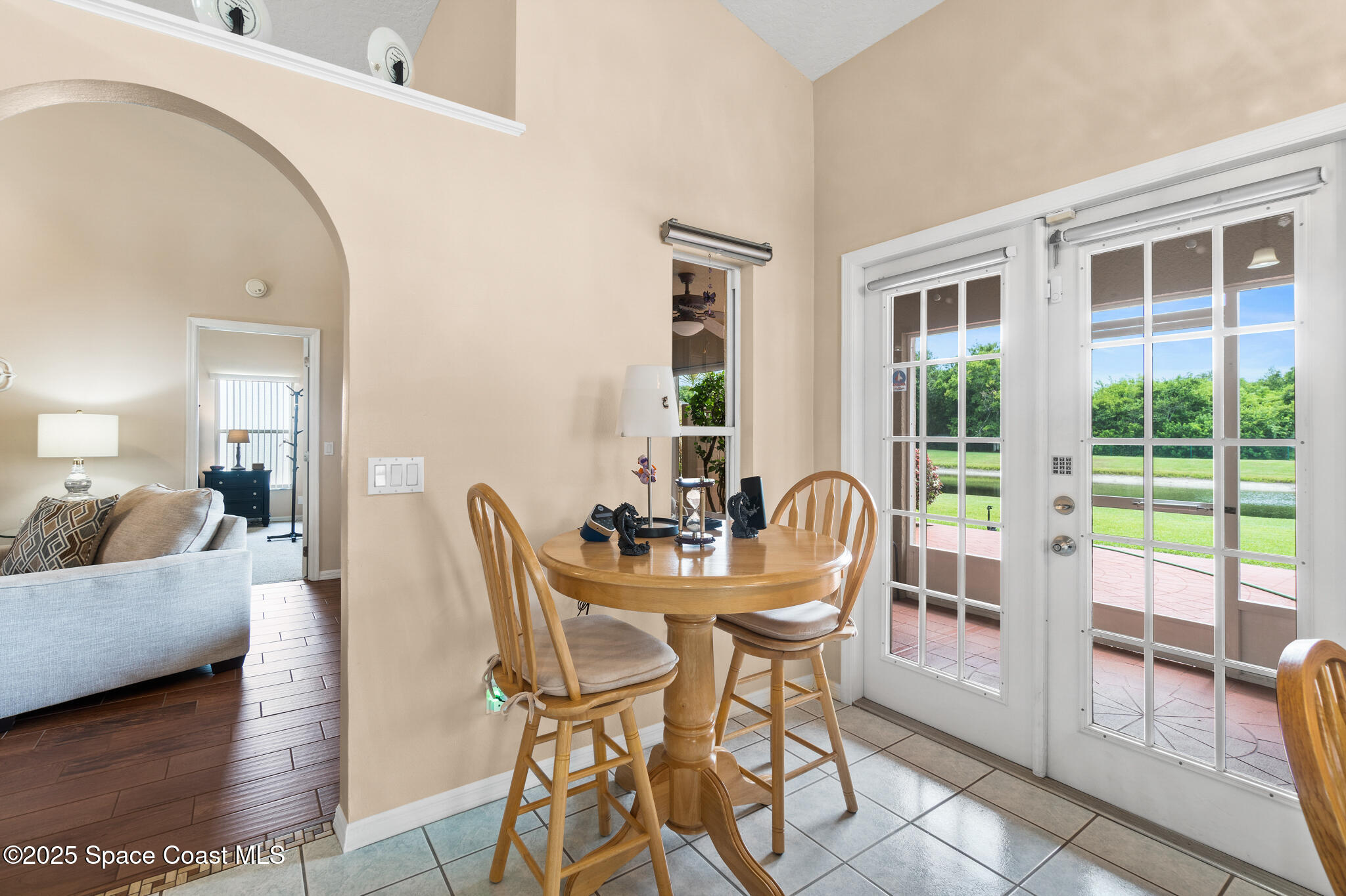 4808 Springwater Circle Melbourne, FL 32940 - Photo 9 of 38 a dining room with furniture and large windows