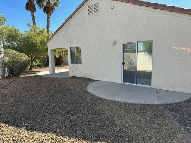 285 Spring Palms Street Henderson, NV 89012 - Photo 21 of 38 Rear view of house with a patio and stucco siding