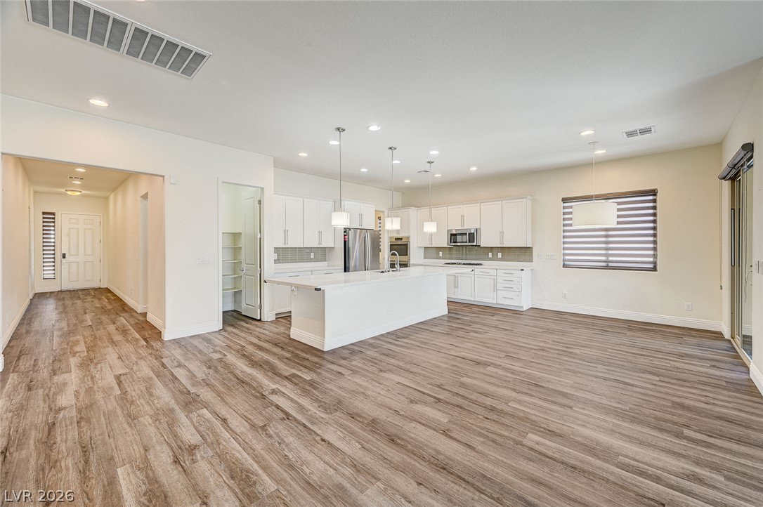 8197 Riley Love Street Las Vegas, NV 89139 - Photo 13 of 48 An open concept kitchen features abundant counter space and flows into a generously proportioned living area.