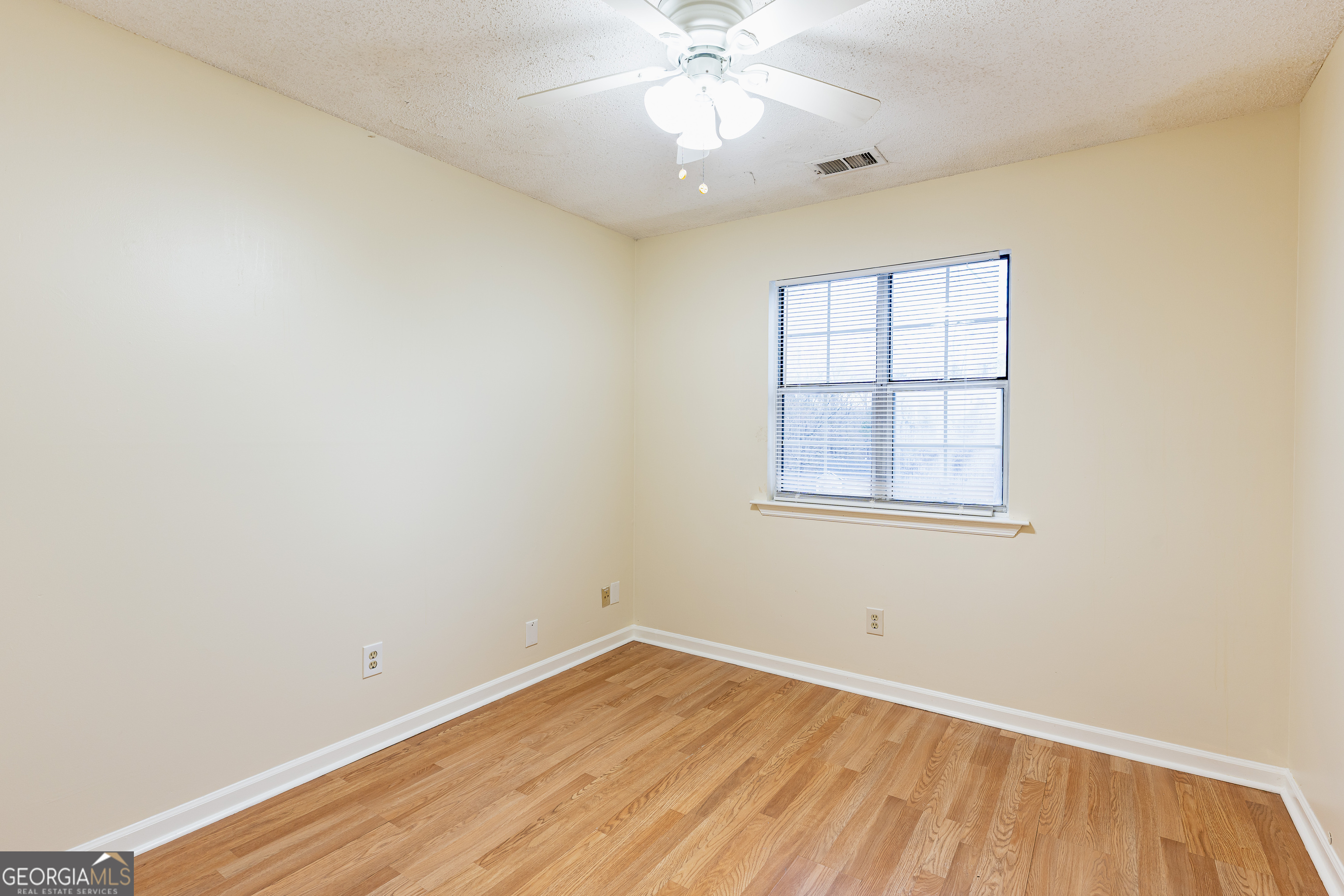 3821 Rex Mill Square Rex, GA 30273 - Photo 18 of 51 an empty room with a window and wooden floor
