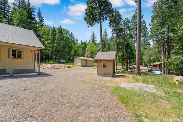 a view of a house with backyard and a tree