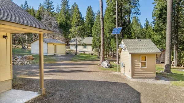 a view of a house with a yard and tree s