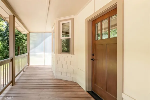 a view of a porch with wooden floor and stairs