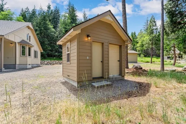 a view of a small house with a yard