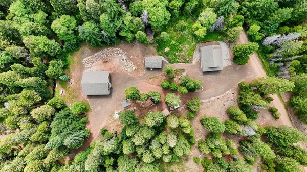 an aerial view of a house with a yard and garden